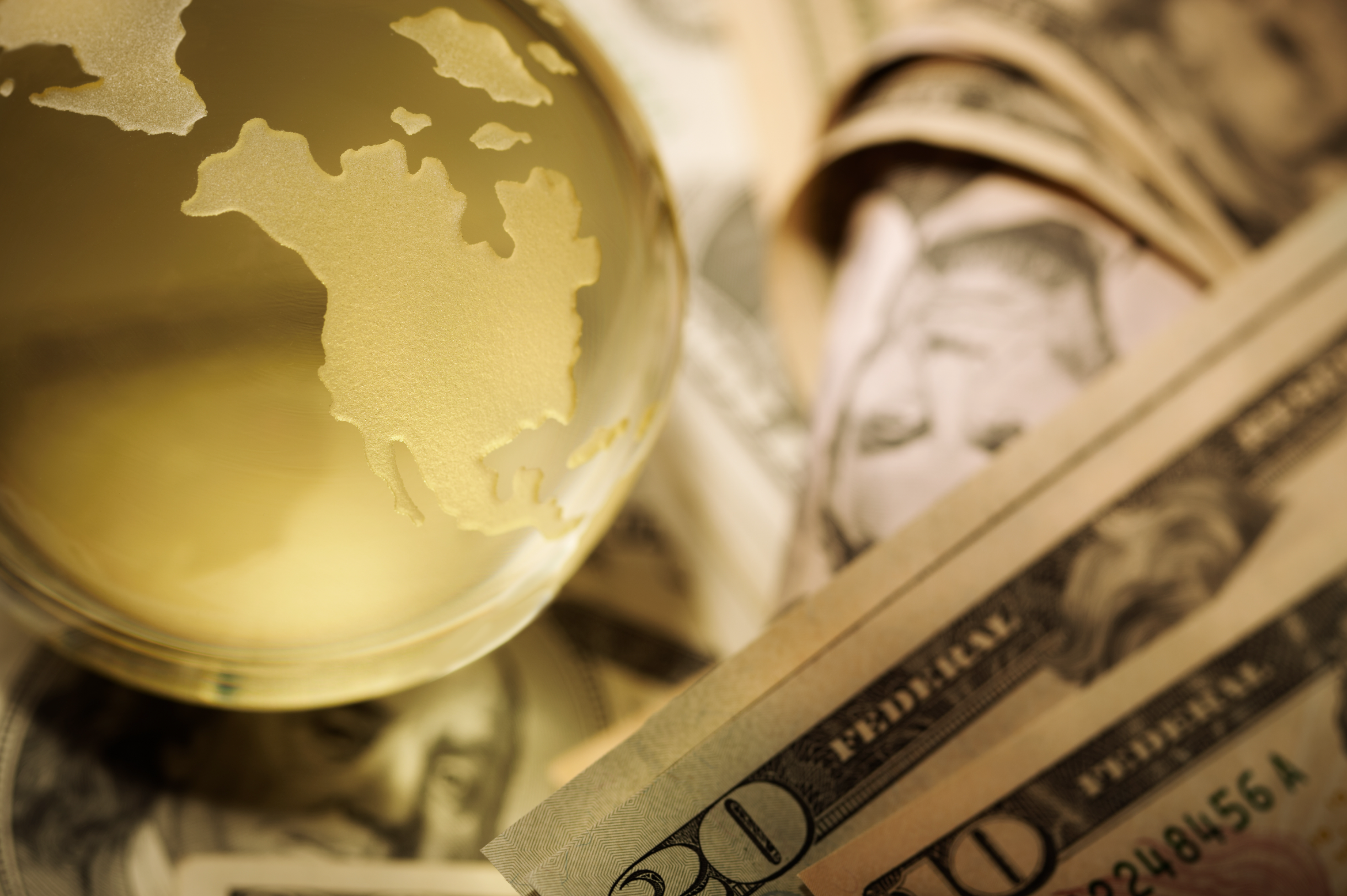 Picture of money on a table with crystal globe