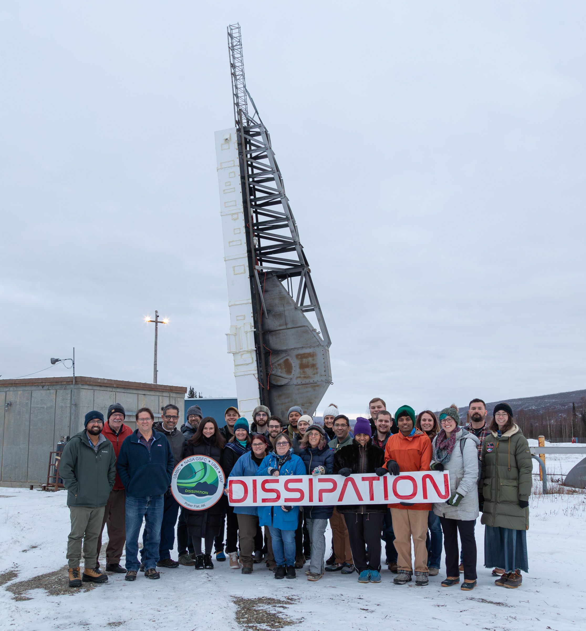 A group of people holding a banner that says "DISSIPATION"